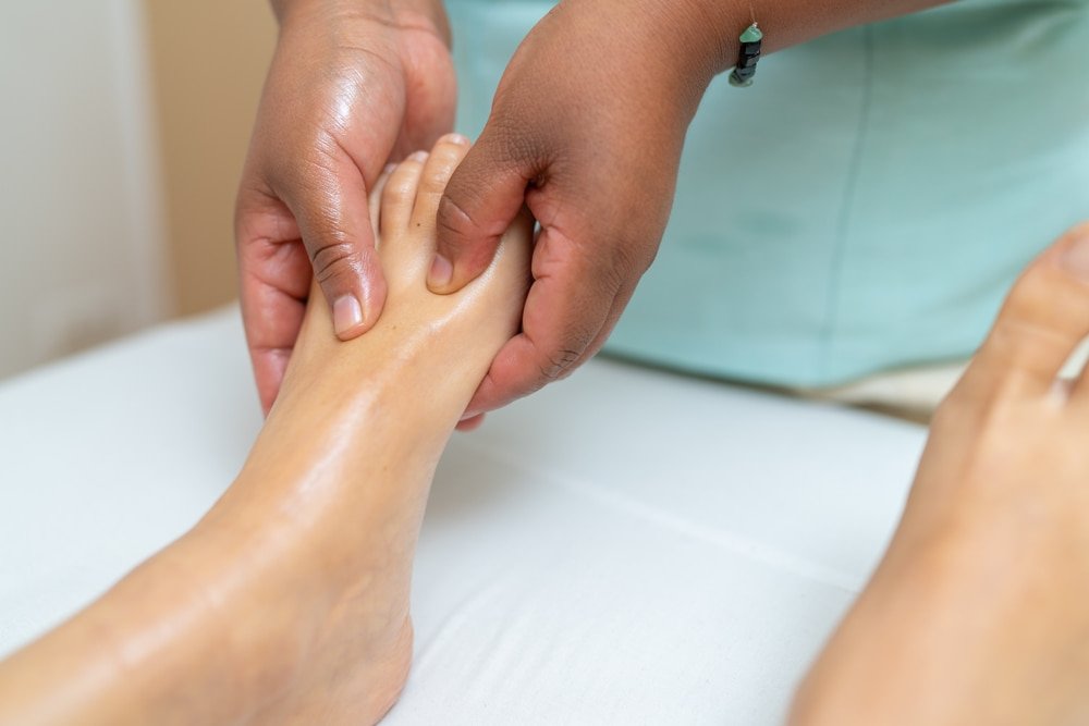 A close-up shot of a foot massage with oils