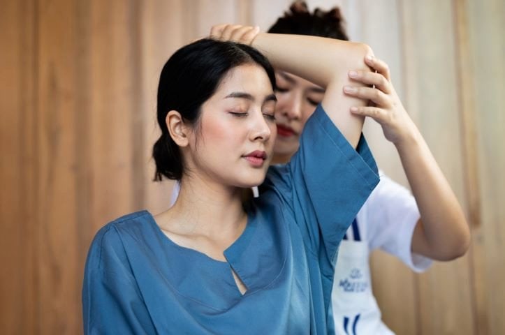 A woman enjoying a traditional Thai massage