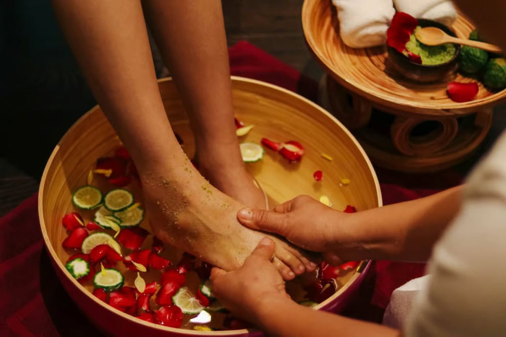 Customer getting a foot wash before a Thai massage