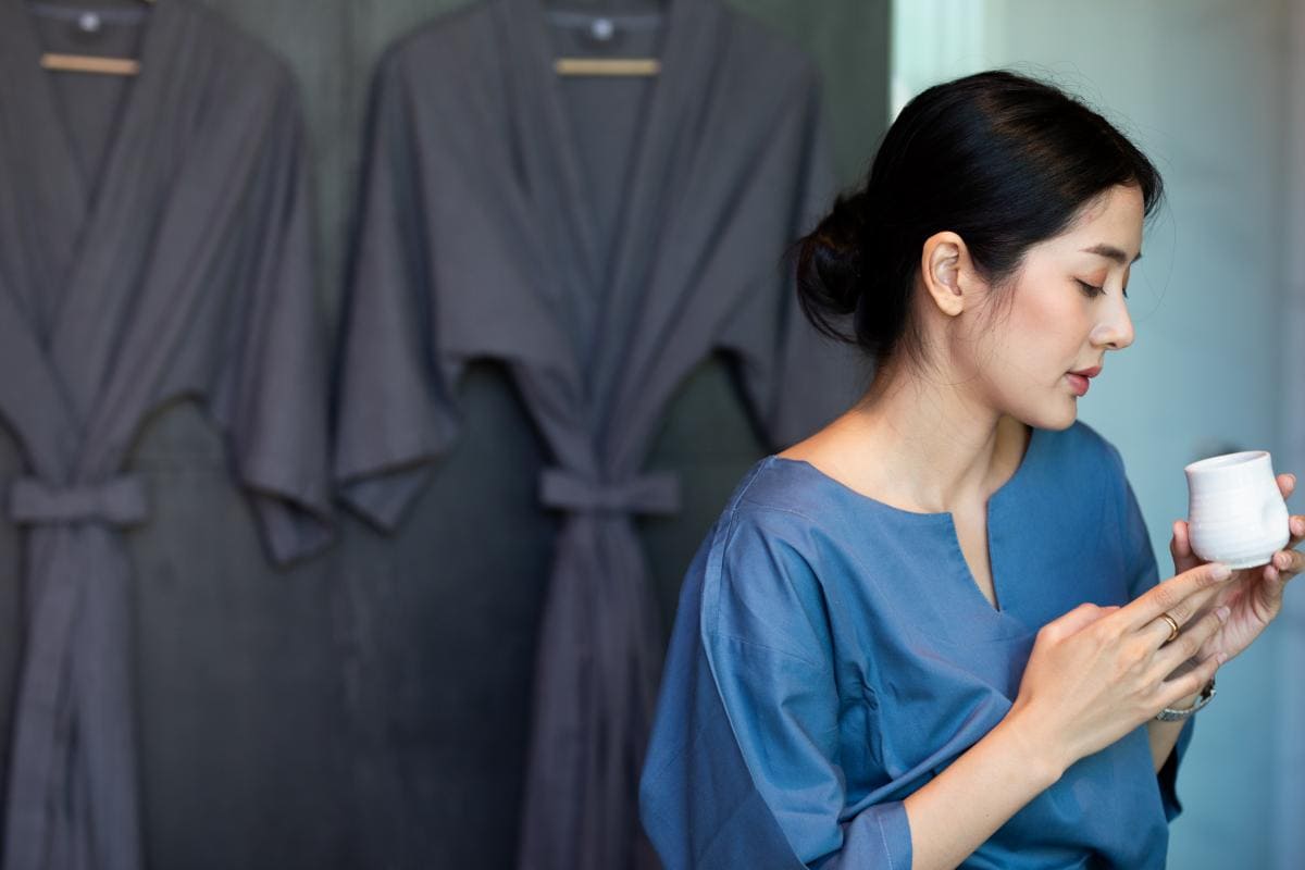 A woman enjoying a complimentary tea after her massage