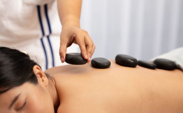 Our therapist placing heated stones on a customer’s back